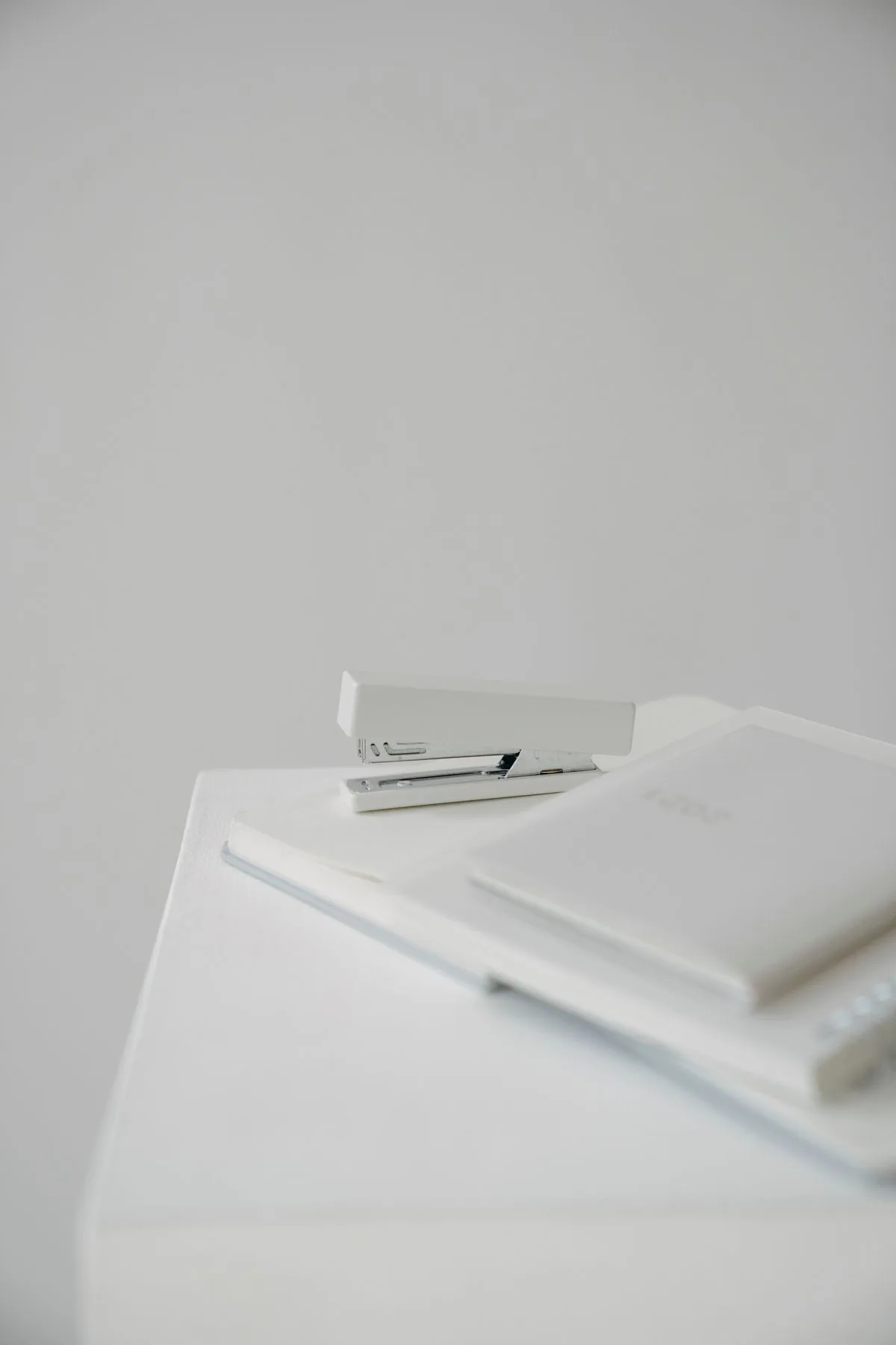 White office stapler on a white desk